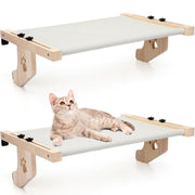 Two wooden cat window perches with paw print cutouts, one empty and one with orange tabby cat