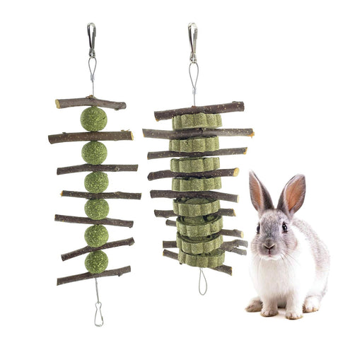 Two natural apple wood chew toys with green hay balls and compressed blocks beside gray rabbit