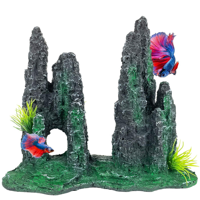 Gray rock aquarium cave ornament with green algae, artificial plants, and colorful betta fish