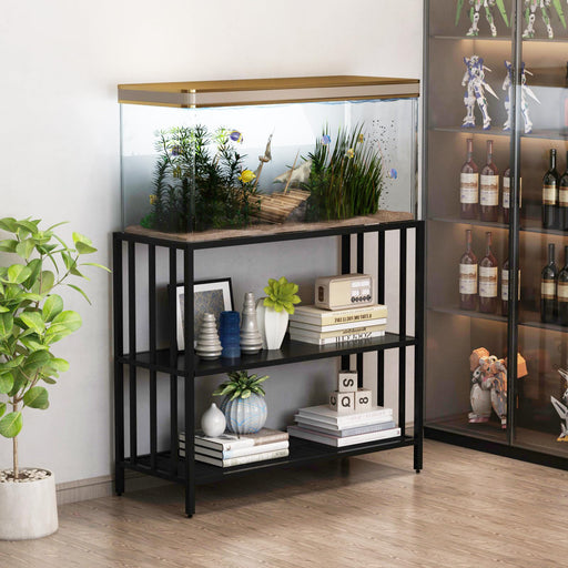 Black metal aquarium stand holding fish tank with decorative shelves displaying books and plants