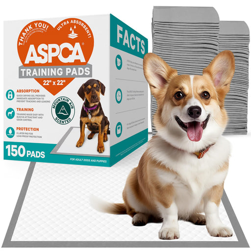 Corgi dog sitting on ASPCA training pad with product box showing 150 ultra absorbent pads