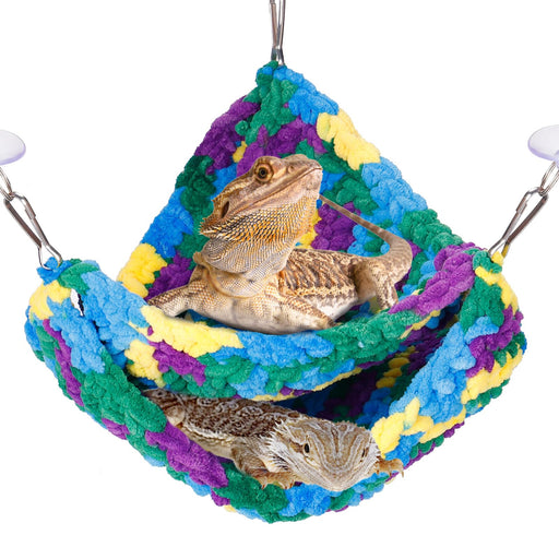Two bearded dragons relaxing in a colorful multi-level fleece hammock with blue, green, purple