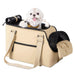 Small white dog with pink tongue sitting in beige soft-sided pet carrier with mesh panels