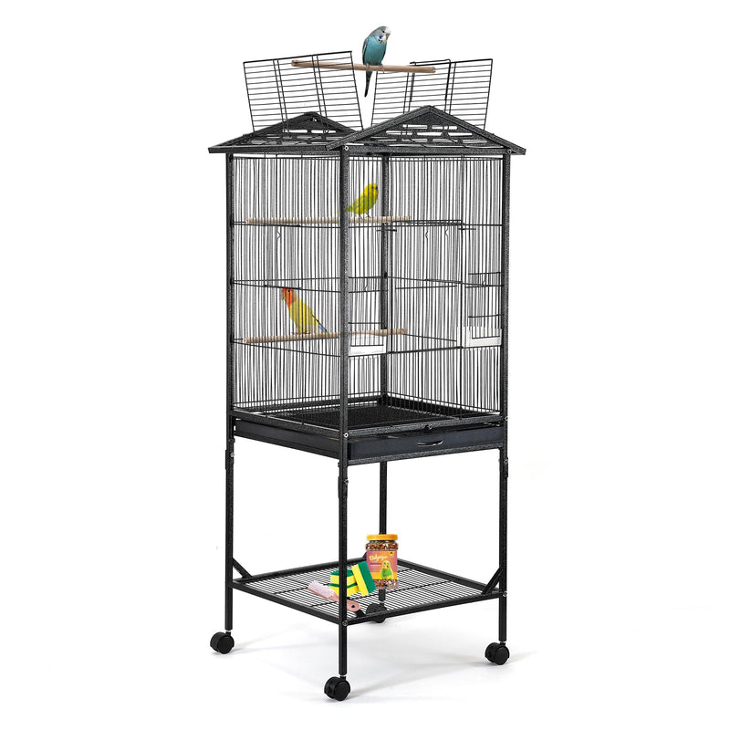 Black wrought iron bird cage on wheels with two colorful parrots inside and one perched on top
