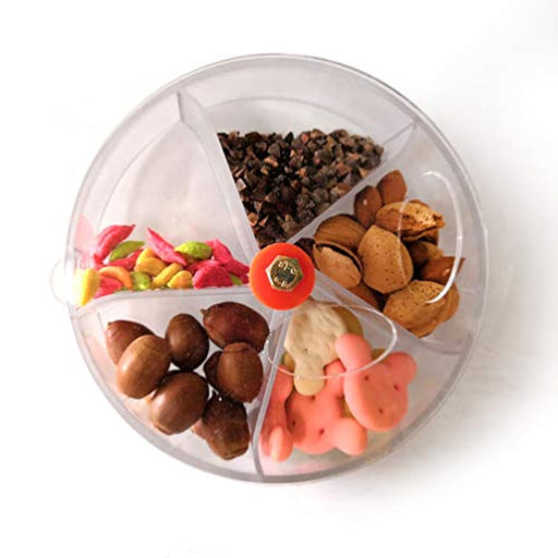 Clear rotating bird feeder wheel filled with colorful treats including nuts, seeds, and candies