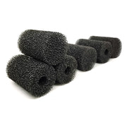 Multiple black aquarium pre-filter sponges arranged on white background showing texture