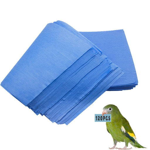 Stack of blue absorbent bird cage liner papers fanned out with green parrot shown for scale