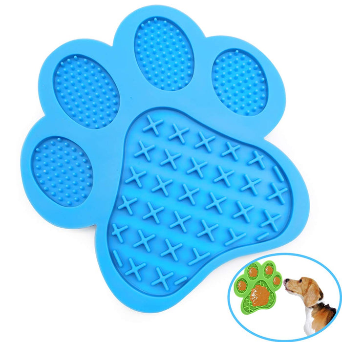 Blue paw-shaped dog lick mat with textured surface and small inset showing dog using green version