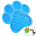 Blue paw-shaped silicone dog lick mat with textured surfaces and circular bubble sections
