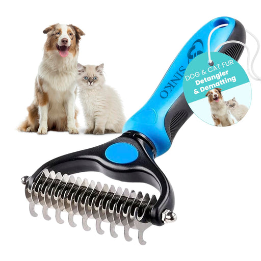 Blue and black pet grooming rake with metal teeth next to Australian Shepherd and white cat