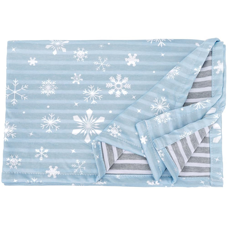 Light blue dog blanket with white snowflake pattern, corner folded to show gray striped reverse side