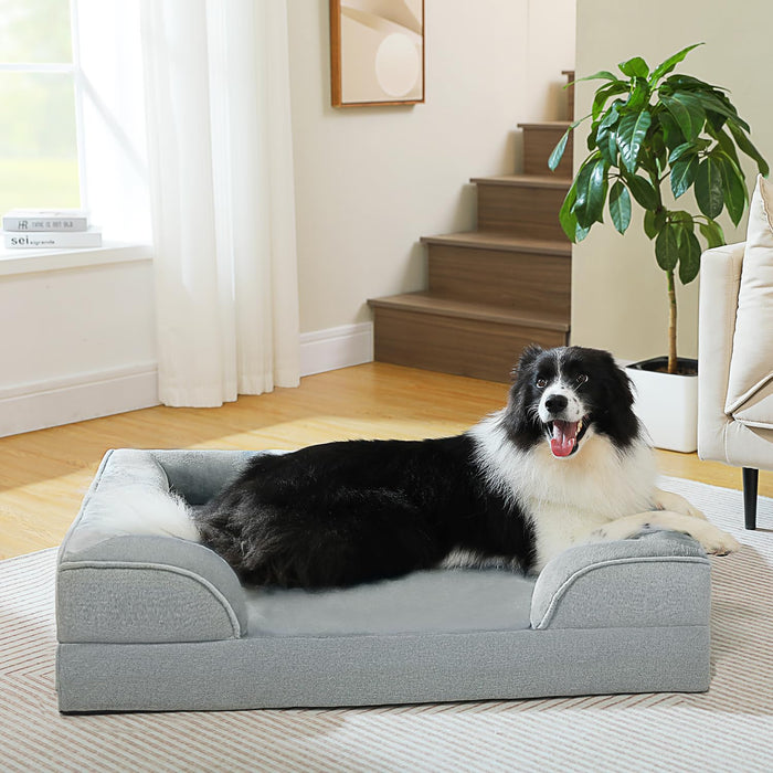 Black and white Border Collie lying on gray orthopedic memory foam dog bed in modern home