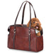 Brown leather pet carrier bag with small curly-haired dog peeking out from mesh opening