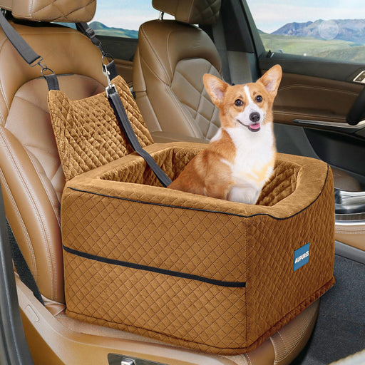 Orange corgi sitting in brown quilted dog car booster seat with safety straps in vehicle interior