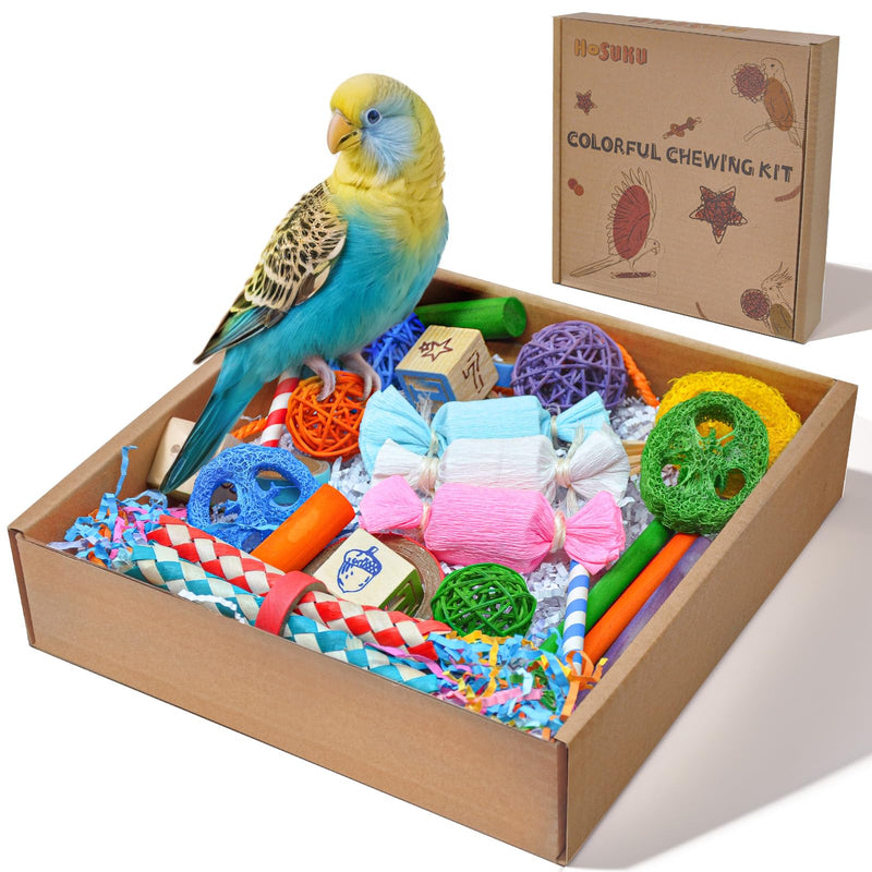 Yellow and blue budgie perched on colorful bird chewing toy kit with woven balls and ropes