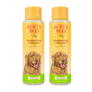 Two bottles of Burt's Bees deodorizing dog shampoo with apple and rosemary on white background