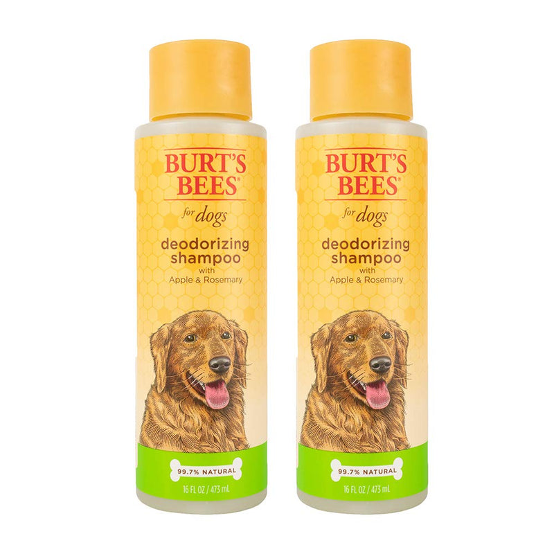 Two bottles of Burt's Bees deodorizing dog shampoo with apple and rosemary on white background