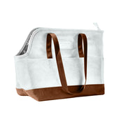 White canvas dog carrier bag with brown leather base and handles shown from side angle