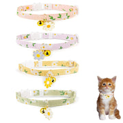 Four floral cat collars with daisy charms and bells shown with orange tabby kitten modeling one