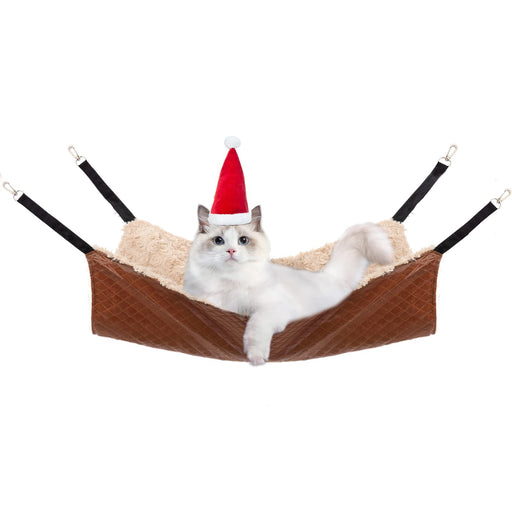 White cat wearing Santa hat relaxing in brown quilted hanging pet hammock