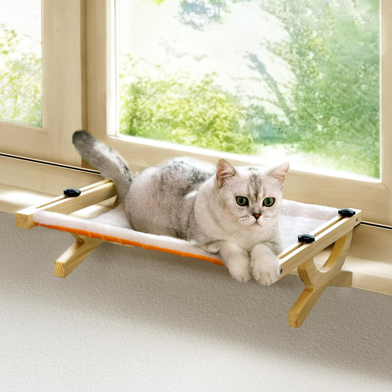 Silver tabby cat relaxing on wooden window hammock with white fabric near bright window