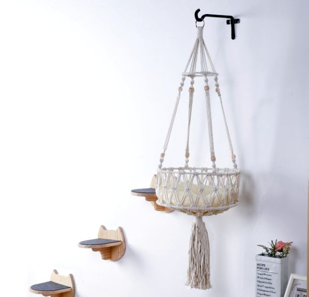 A macrame cat hammock with included wall steps for an elevated sanctuary for your cat.