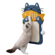 White cat stretching up to scratch blue and orange fish-shaped wall-mounted scratching post