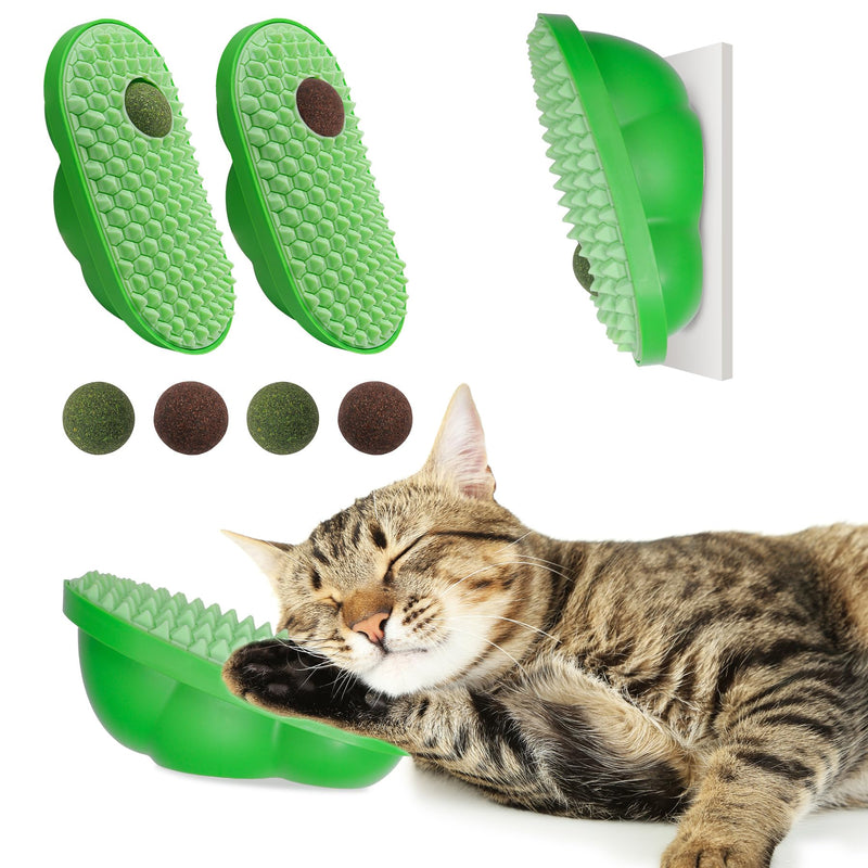 Tabby cat using green textured grooming brush with catnip ball attachment on white background