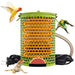 Green ceramic heat lamp with protective cage, heating coil visible, surrounded by colorful birds