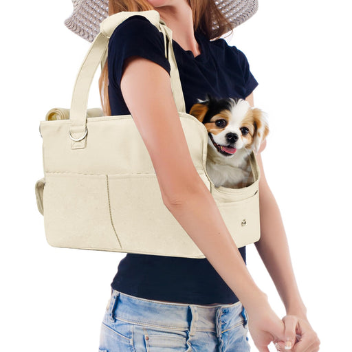 Woman wearing beige Oxford dog carrier purse with small Chihuahua dog's head visible in opening