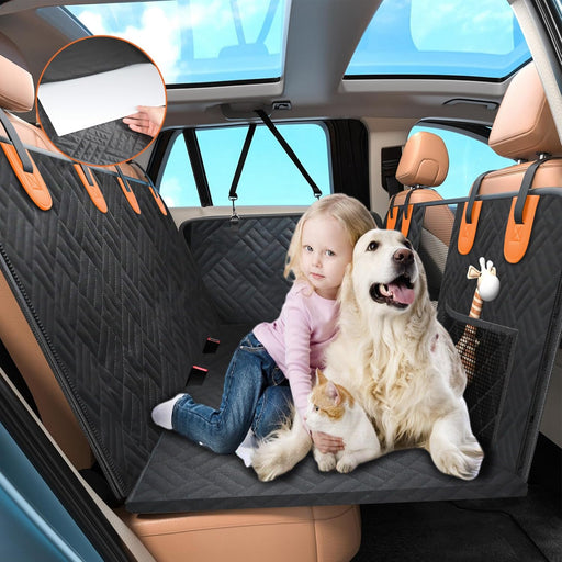 Child and golden retriever sitting on black quilted dog car hammock with orange accents