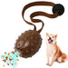 Brown spiked ball dog toy with long strap and treat dispenser feature next to happy Shiba Inu