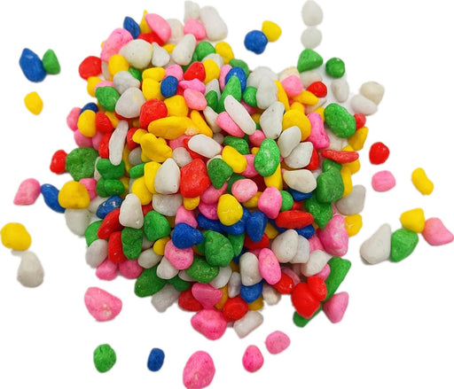 Pile of colorful small aquarium gravel stones in red, blue, green, pink, yellow and white