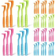 Colorful plastic tick removal tools in orange, green, pink and blue arranged in groups