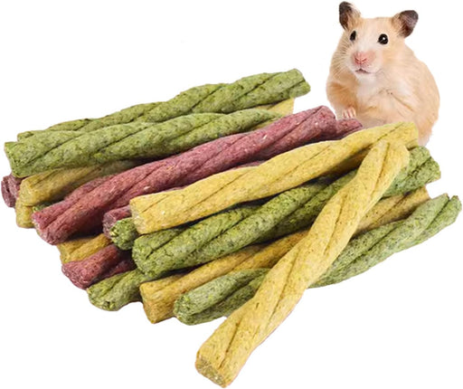 Colorful twisted chew sticks in green, yellow and purple with hamster positioned behind them