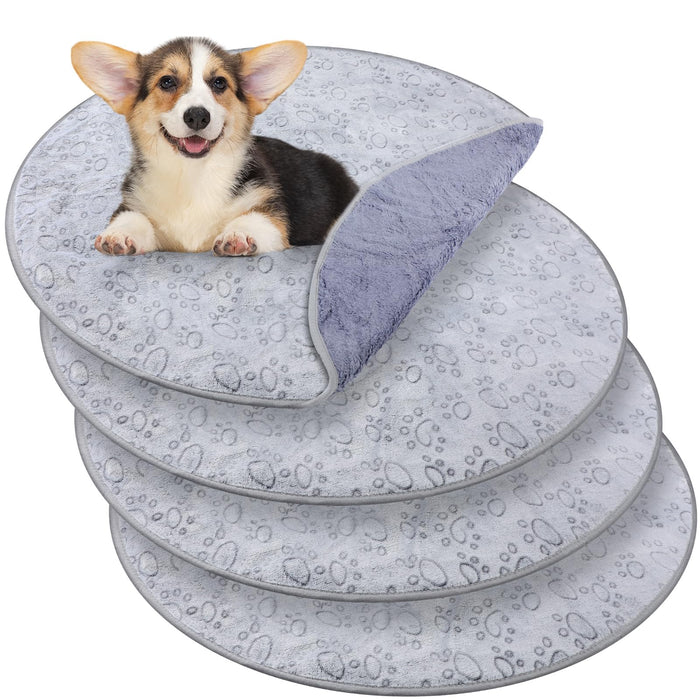 Gray waterproof training pads with paw prints in four stacked layers with corgi puppy on top