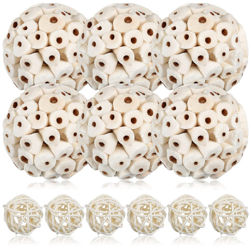 Six white cylindrical rattan foraging balls and six woven rattan spheres arranged on white