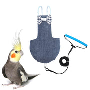 Denim bird flight harness with striped bow tie and blue leash next to yellow-crested cockatiel