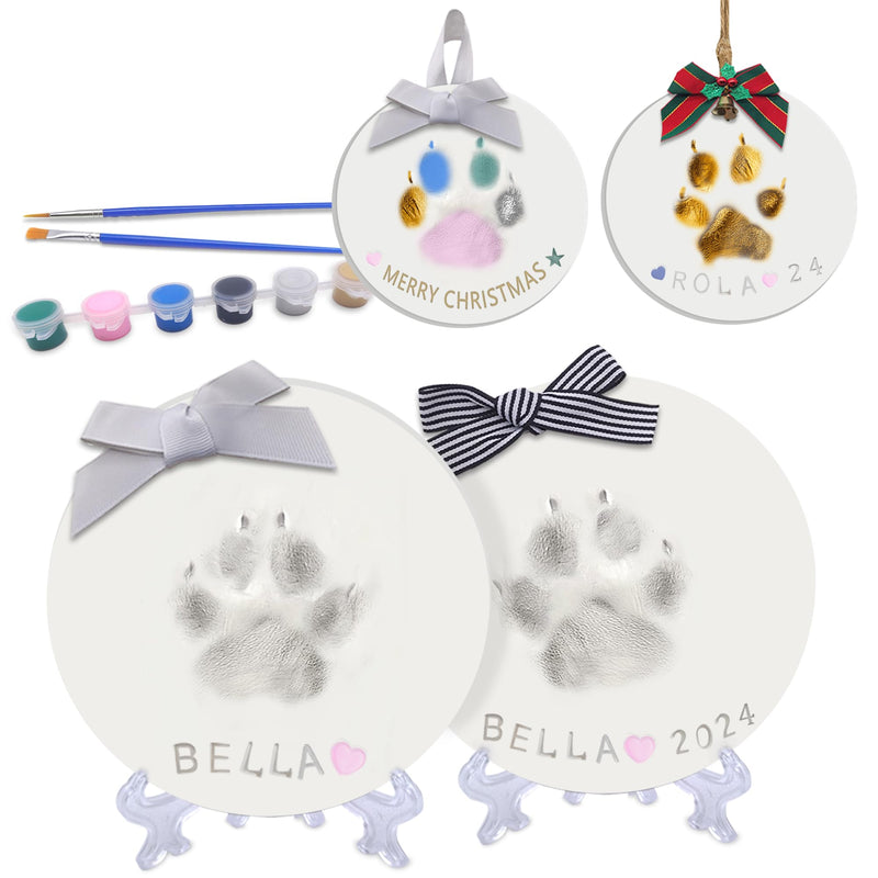 DIY clay paw print keepsake kit showing two white ornaments named Bella with paints and brushes
