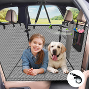 Young girl and yellow Labrador sitting on gray quilted car seat cover with mesh barrier and