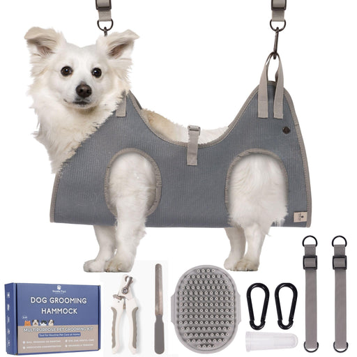 White fluffy dog in gray grooming hammock with complete kit accessories displayed below