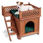 Jack Russell terrier resting on upper deck of two-level wooden pet house with green cushion
