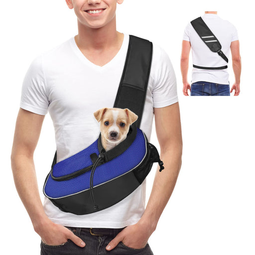 Man wearing white shirt with small puppy in blue and black sling carrier across chest