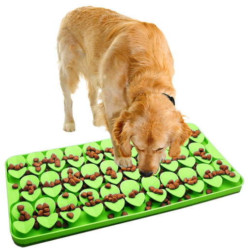 Golden retriever using green silicone snuffle mat with heart-shaped compartments filled with kibble