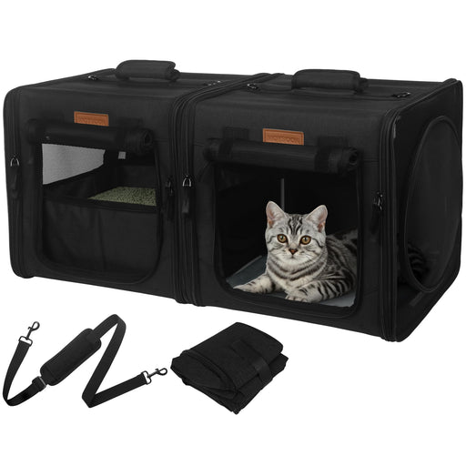 Black pet carrier duo with silver tabby cat inside right compartment, shoulder strap shown below