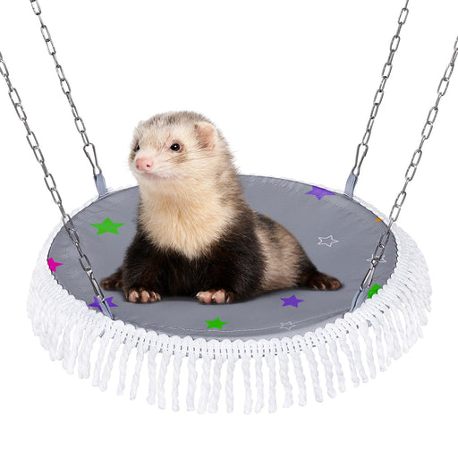 Ferret sitting on gray star-patterned hammock with white fringe suspended by metal chains