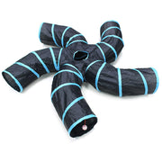 Black collapsible cat tunnel system with blue trim arranged in 5-way star configuration on white