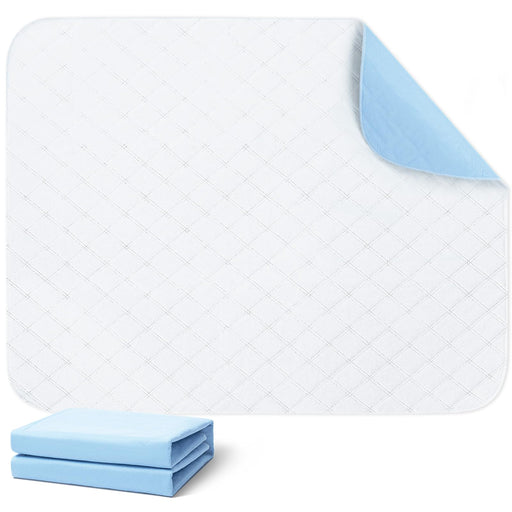 White quilted washable dog training pad with blue backing corner folded up and stacked pads below