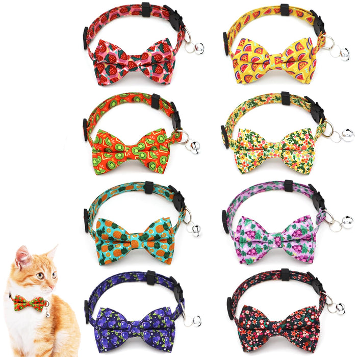 Eight colorful cat bow tie collars with fruit patterns including strawberries, watermelon, and kiwi