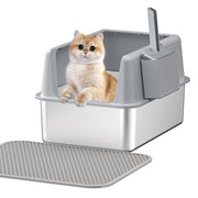 Orange and white kitten sitting inside gray cat litter box with open lid and textured mat
